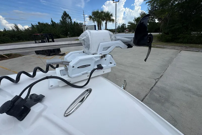 Slide: The Image of 2027 Caymas 281 HB boat with Power-Pole anchor system, parked outdoors. - 24