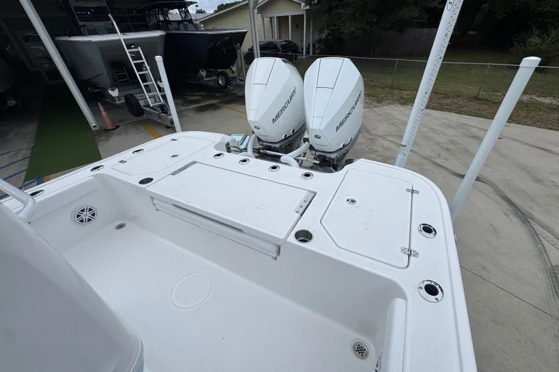 Slide: The Image of 2027 Caymas 281 HB boat with dual Mercury outboard engines, docked in a marina. - 45