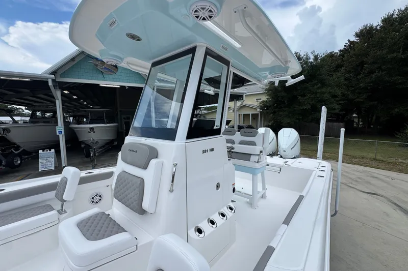 Slide: The Image of 2027 Caymas 281 HB boat with sleek design and modern features, docked outdoors. - 28