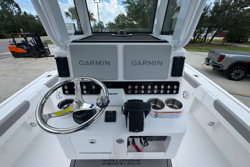 Slide: The Image of 2027 Caymas 281 HB boat dashboard with Garmin displays and steering wheel. - 36