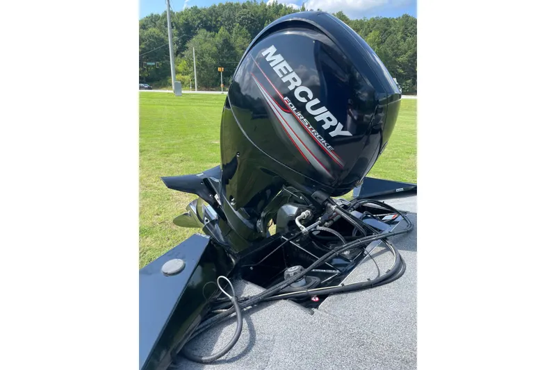 Slide: The Image of 2018 Tracker Pro Team 195 TXW boat with Mercury FourStroke engine on grassy area. - 13