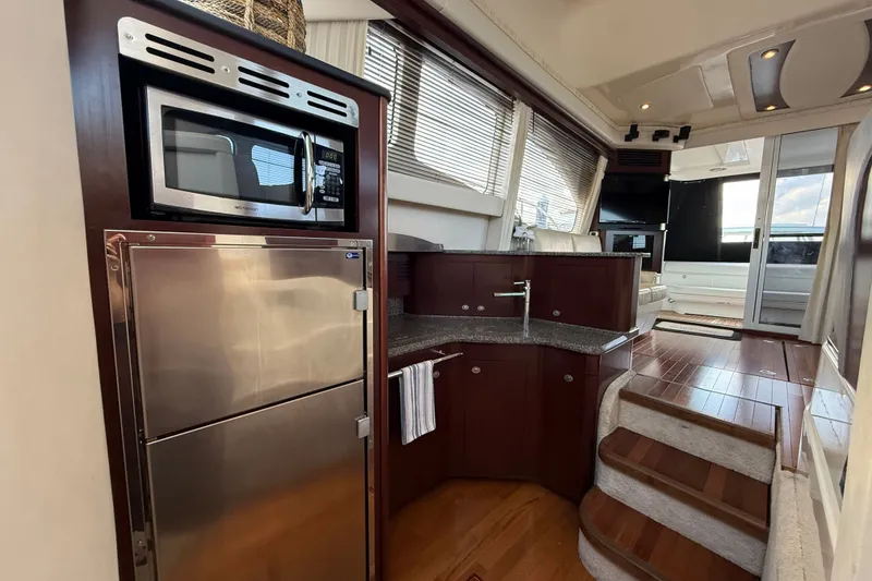 Slide: The Image of Luxurious interior of 2008 Sea Ray 44 Sedan Bridge yacht with modern kitchen amenities. - 33