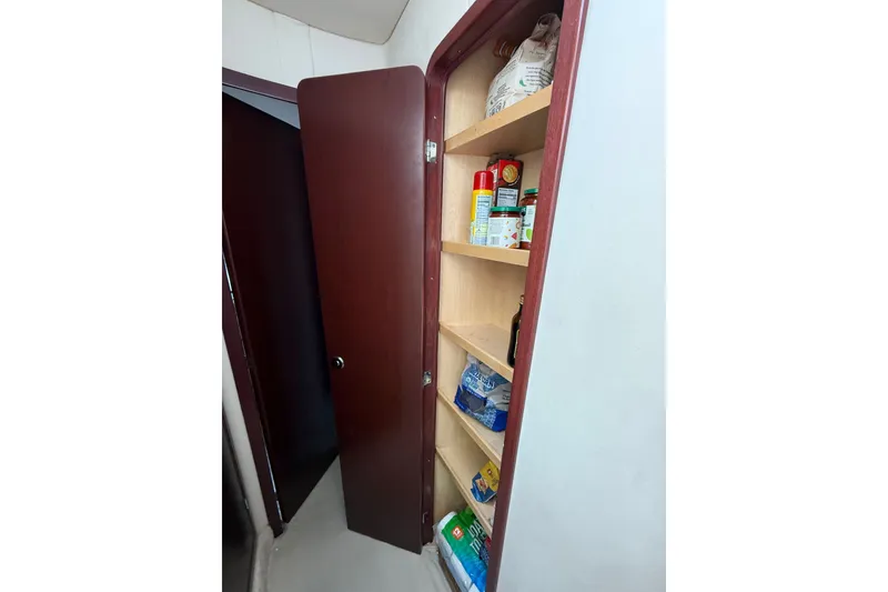 Slide: The Image of Cabinet with pantry items inside a 2008 Sea Ray 44 Sedan Bridge yacht. - 31