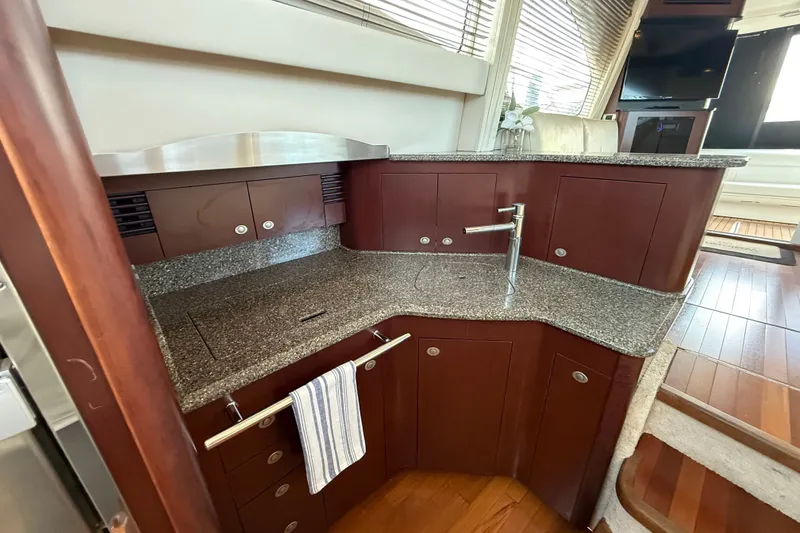 Slide: The Image of Luxurious 2008 Sea Ray 44 Sedan Bridge yacht kitchen with granite countertops and modern fixtures. - 29