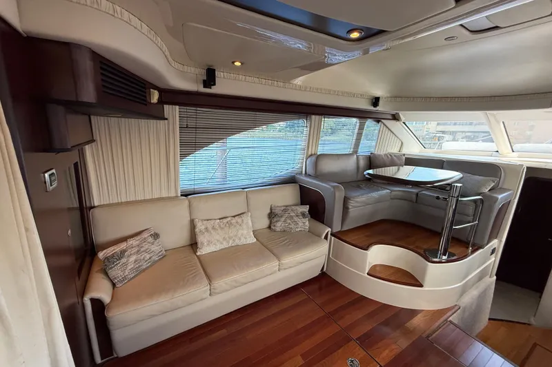 Slide: The Image of Luxurious interior of 2008 Sea Ray 44 Sedan Bridge yacht with elegant seating and wooden flooring. - 22