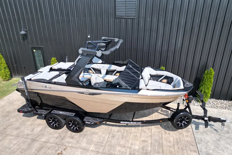 Slide: The Image of 2027 Tige Z1 boat on trailer, sleek design, parked outdoors. - 18