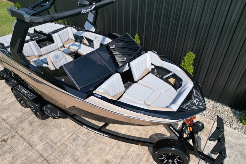 Slide: The Image of 2027 Tige Z1 boat with sleek design and luxurious seating on a trailer. - 17