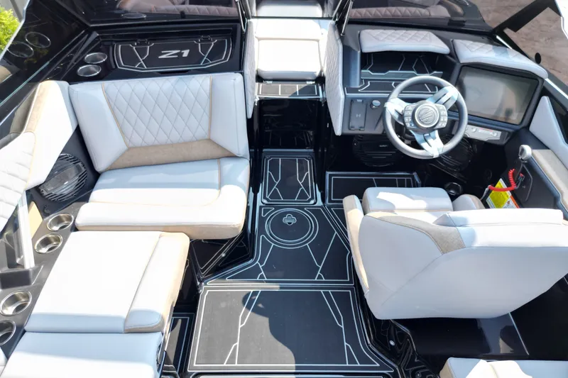 Slide: The Image of Interior of a 2027 Tige Z1 boat featuring modern seating and sleek dashboard design. - 9