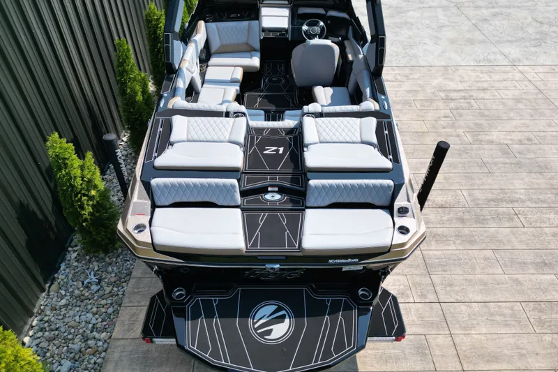 Slide: The Image of 2027 Tige Z1 boat with luxurious seating and modern design, docked on wooden platform. - 12