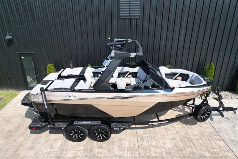 Slide: The Image of 2027 Tige Z1 boat on trailer, sleek design, parked outdoors. - 19