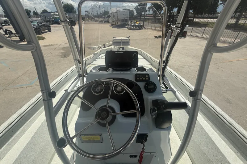 Slide: The Image of 2021 Excel 203 Bay Pro boat dashboard with steering wheel and controls. - 12