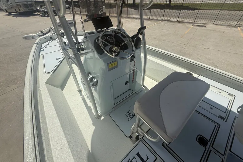 Slide: The Image of 2021 Excel 203 Bay Pro boat interior with steering console and seating. - 8