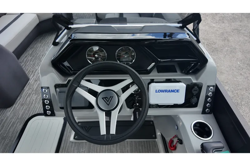 Slide: The Image of Cockpit of 2027 Viaggio X22S boat featuring steering wheel and Lowrance navigation system. - 13