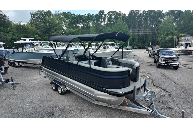 Slide: The Image of 2027 Viaggio X22S pontoon boat on trailer in outdoor dealership setting. - 2