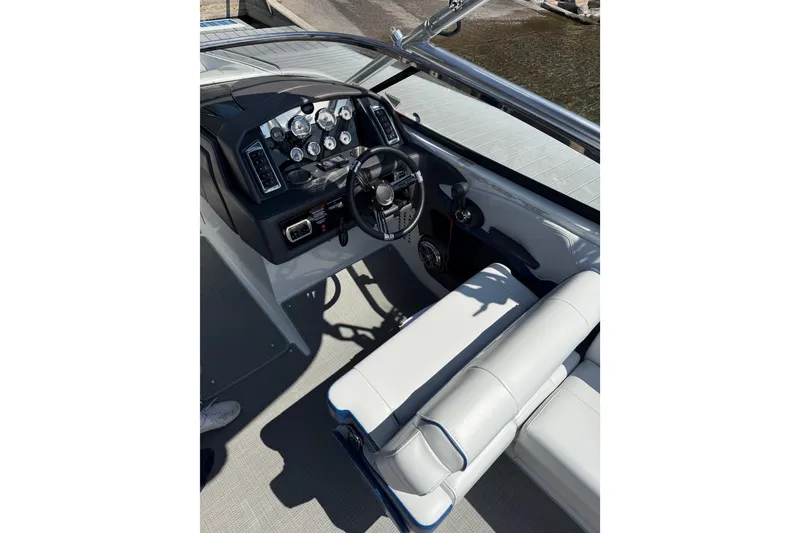 Slide: The Image of 2022 Formula 270 Bowrider boat cockpit with steering wheel and control panel. - 12
