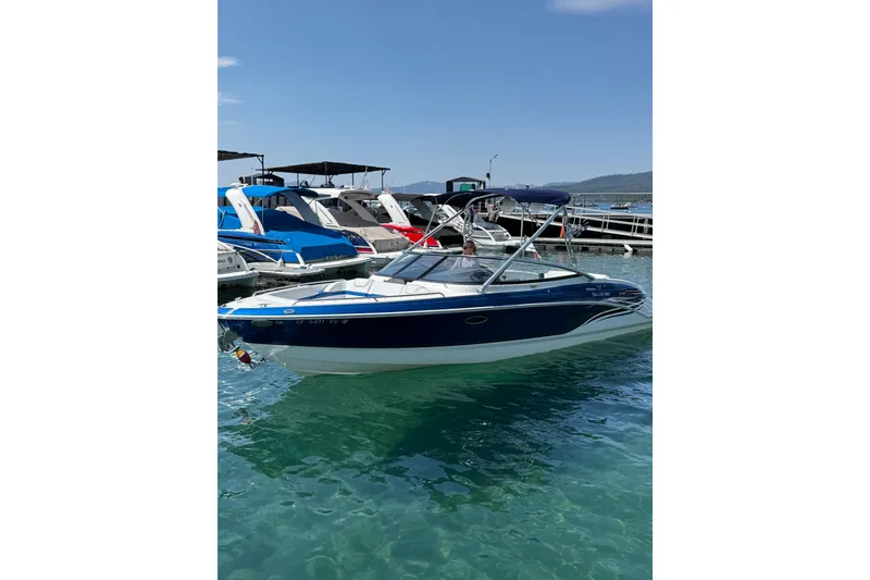 Slide: The Image of 2022 Formula 270 Bowrider boat docked in clear blue water. - 2