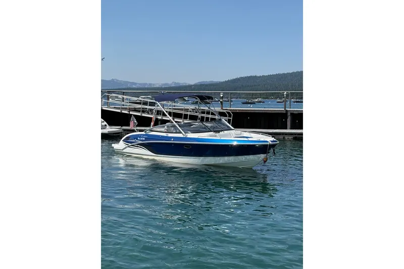 Slide: The Image of 2022 Formula 270 Bowrider boat on clear blue water near a dock. - 3