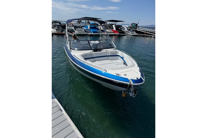 Slide: The Image of 2022 Formula 270 Bowrider docked in a marina, showcasing sleek design and spacious seating. - 7