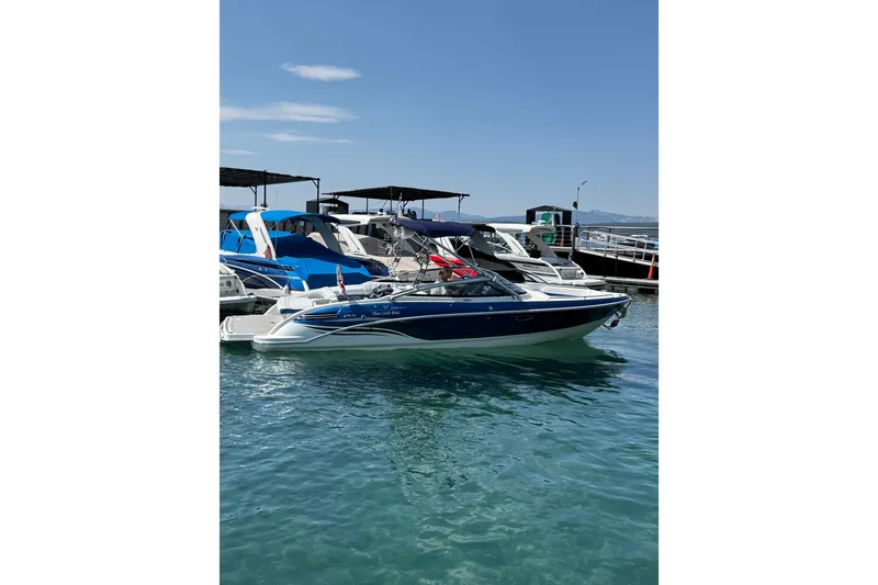 Slide: The Image of 2022 Formula 270 Bowrider boat docked in clear blue water. - 4