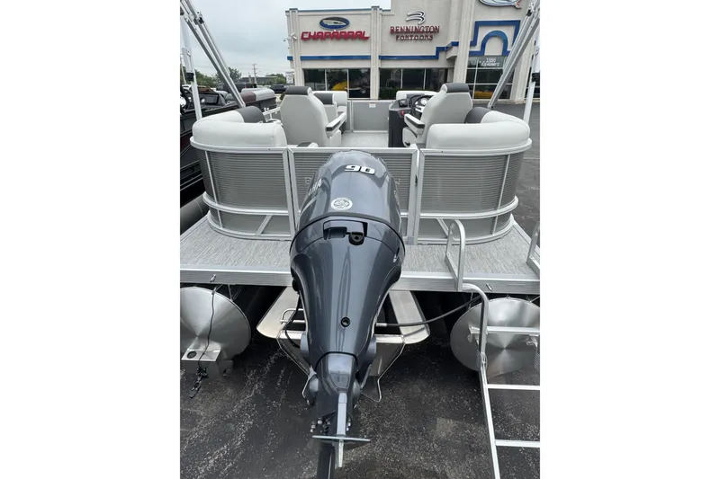 Slide: The Image of 2026 Bennington S 20 SSR pontoon boat with outboard motor, displayed at dealership. - 14