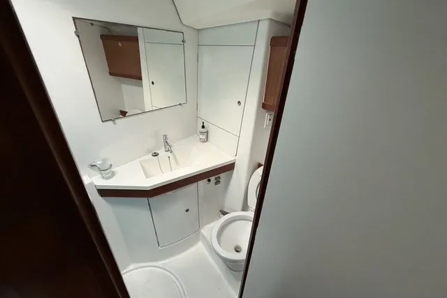 Slide: The Image of 2008 Beneteau Oceanis 46 yacht bathroom with sink, mirror, and toilet. - 50