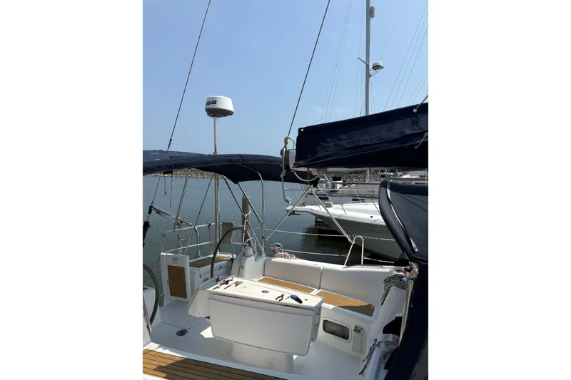 Slide: The Image of 2008 Beneteau Oceanis 46 sailboat cockpit with blue canopy in marina setting. - 10
