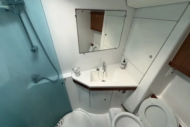 Slide: The Image of Bathroom interior of 2008 Beneteau Oceanis 46 yacht, featuring shower, sink, and toilet. - 51