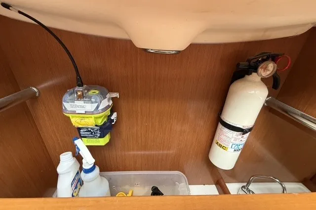 Slide: The Image of Under-sink storage on 2008 Beneteau Oceanis 46 with fire extinguisher and cleaning supplies. - 65