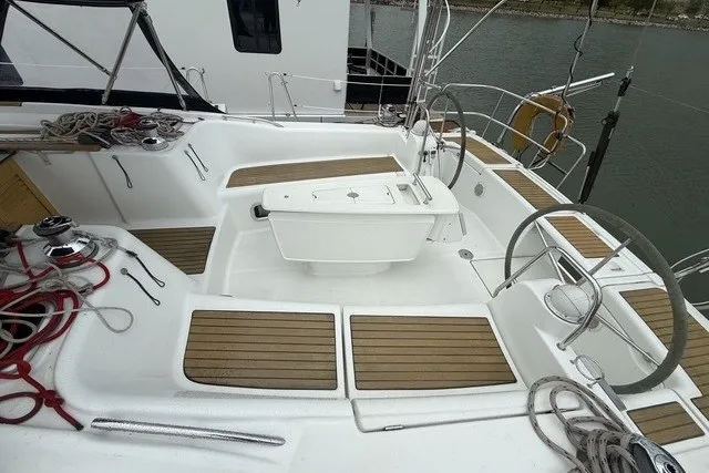 Slide: The Image of 2008 Beneteau Oceanis 46 sailboat cockpit with dual steering wheels and teak flooring. - 15