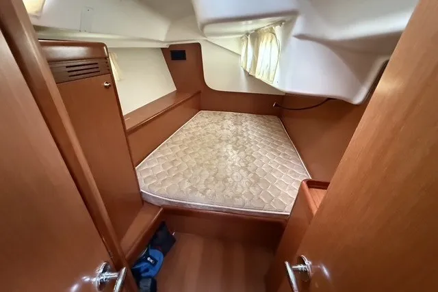 Slide: The Image of Cabin interior of 2008 Beneteau Oceanis 46 sailboat with wooden finish and mattress. - 55
