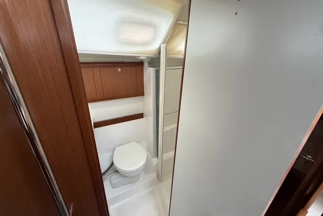 Slide: The Image of Beneteau Oceanis 46 (2008) yacht bathroom with wooden cabinetry and modern fixtures. - 52