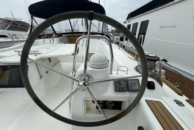 Slide: The Image of Steering wheel of a 2008 Beneteau Oceanis 46 sailboat, docked in a marina. - 18