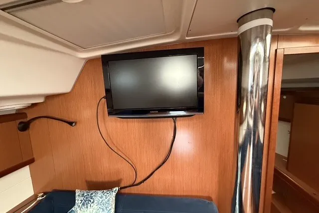 Slide: The Image of Interior of 2008 Beneteau Oceanis 46 yacht with mounted TV and wooden paneling. - 45