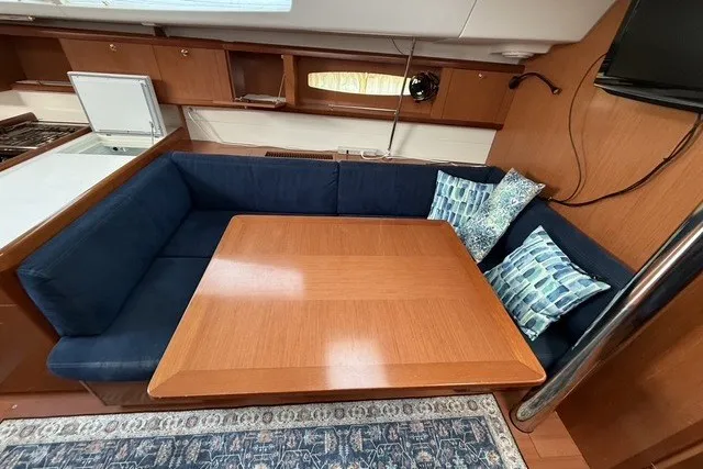 Slide: The Image of Interior of 2008 Beneteau Oceanis 46 yacht with cozy seating and wooden table. - 39