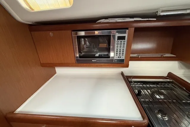 Slide: The Image of Galley kitchen in 2008 Beneteau Oceanis 46 yacht with microwave and stove. - 33
