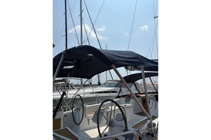 Slide: The Image of 2008 Beneteau Oceanis 46 sailboat cockpit with dual steering wheels and canopy. - 12