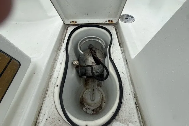 Slide: The Image of Storage compartment on a 2008 Beneteau Oceanis 46 sailboat, featuring a secured gas cylinder. - 29