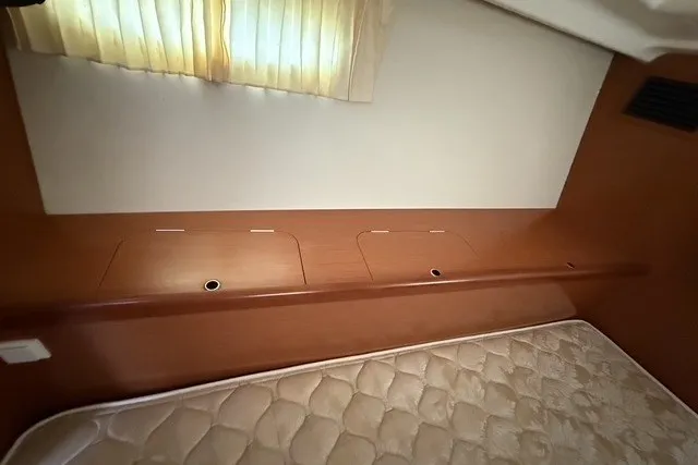 Slide: The Image of Interior cabin of 2008 Beneteau Oceanis 46 yacht with mattress and wooden storage compartments. - 58
