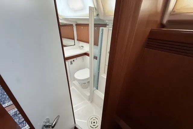 Slide: The Image of Interior view of 2008 Beneteau Oceanis 46 yacht bathroom with wooden cabinetry. - 57
