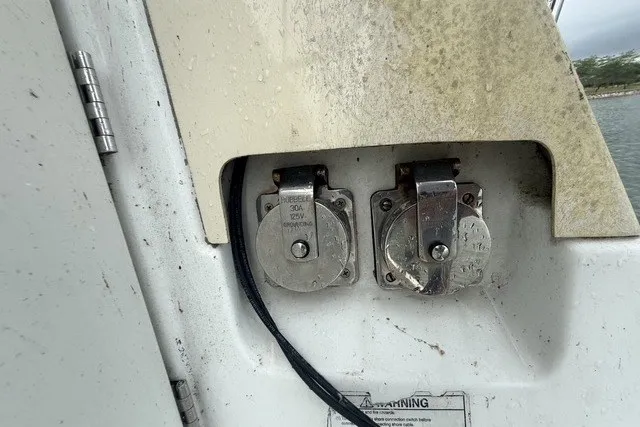 Slide: The Image of Electrical outlets on a 2008 Beneteau Oceanis 46 sailboat, showing wear and marine exposure. - 28