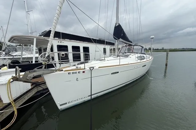 The Image of 2008 Beneteau Oceanis 46 sailboat docked in a marina under cloudy skies. - 1