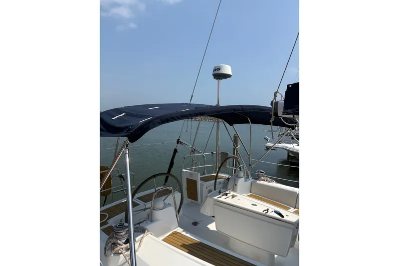 Slide: The Image of 2008 Beneteau Oceanis 46 sailboat cockpit with canopy, docked in a marina. - 11