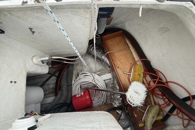 Slide: The Image of Storage compartment of a 2008 Beneteau Oceanis 46 sailboat with cleaning supplies and ropes. - 27