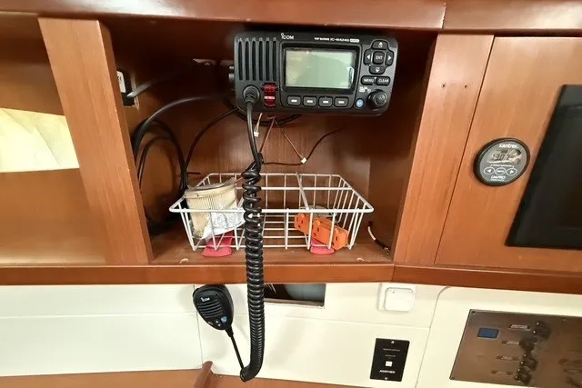 Slide: The Image of 2008 Beneteau Oceanis 46 yacht interior with radio equipment and storage shelves. - 42