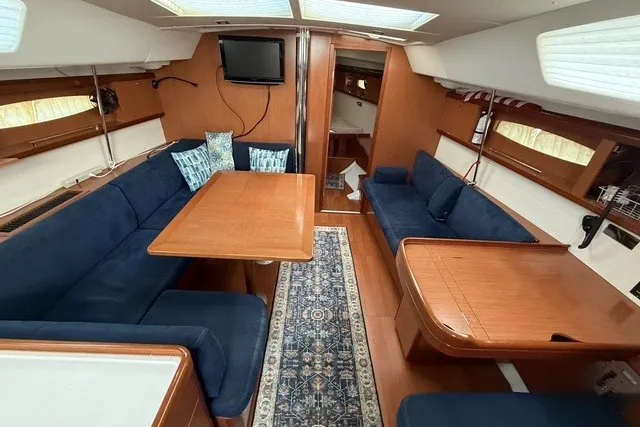 Slide: The Image of Interior of 2008 Beneteau Oceanis 46 yacht with blue seating and wooden furnishings. - 31