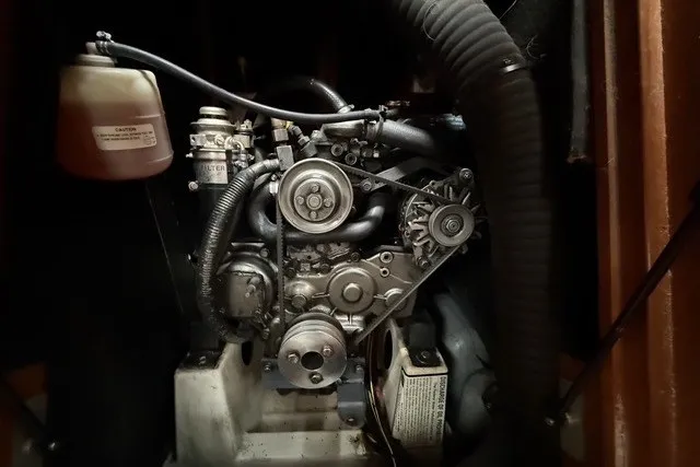 Slide: The Image of Engine compartment of a 2008 Beneteau Oceanis 46 sailboat, showcasing mechanical components. - 64