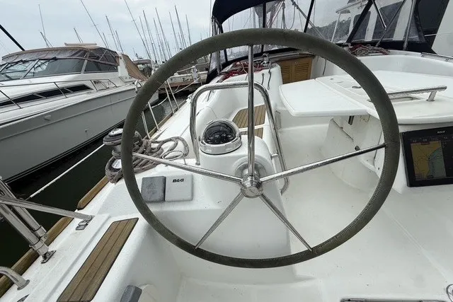 Slide: The Image of Steering wheel of a 2008 Beneteau Oceanis 46 sailboat in a marina. - 17