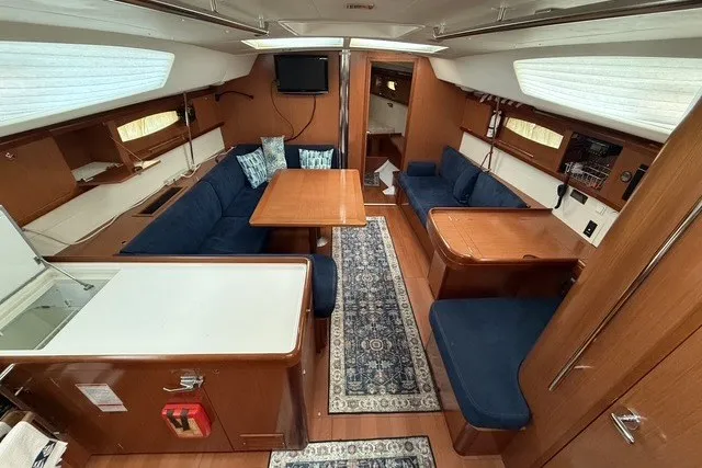Slide: The Image of Luxurious interior of 2008 Beneteau Oceanis 46 yacht with elegant wood finish and blue seating. - 30