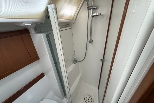 Slide: The Image of Bathroom interior of 2008 Beneteau Oceanis 46 yacht, featuring shower and wooden cabinetry. - 53