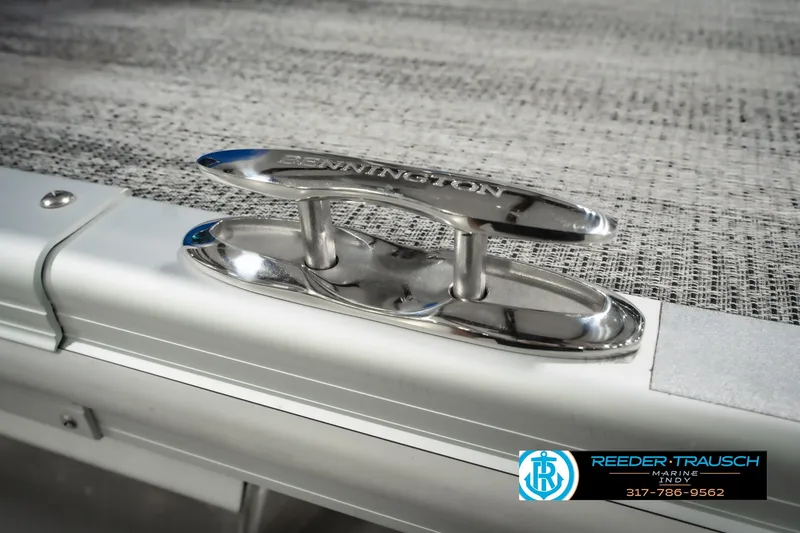 Slide: The Image of 2025 Bennington L 25 Quad Bench Bowrider boat cleat detail, Reeder Trausch Marine logo visible. - 63